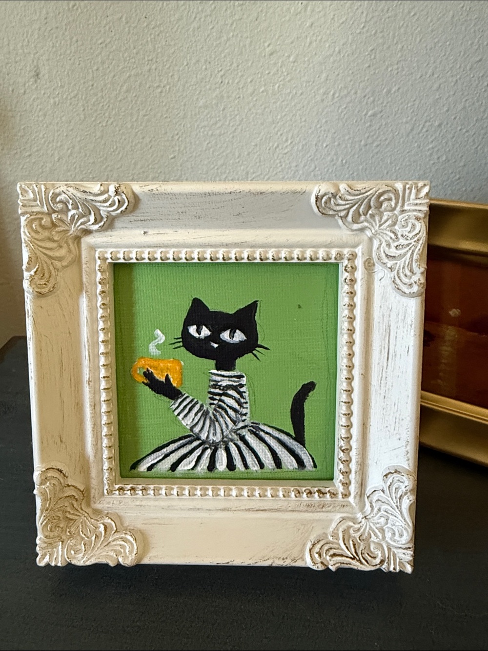 Hand-Painted Black Cat with Mug on Green Background, framed